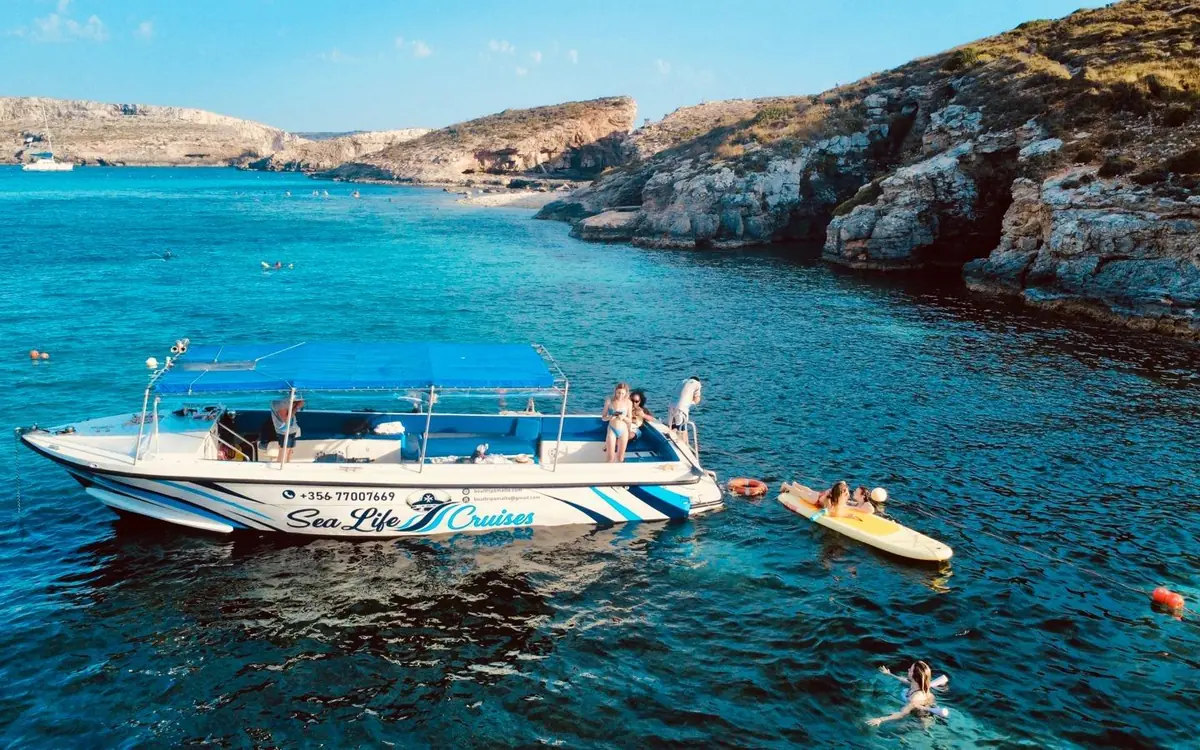 The coast of Comino with clear water and a small boat