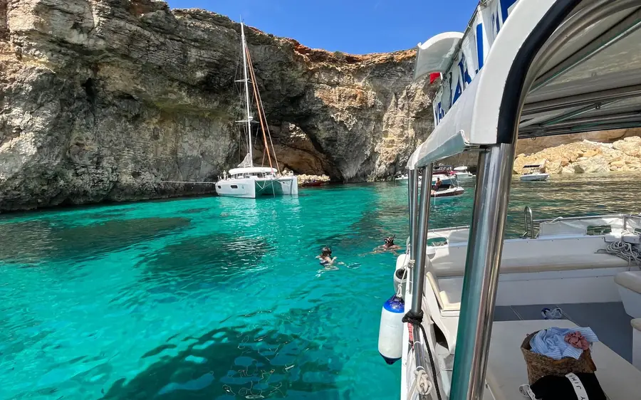 A small tour boat off the coast of Comino