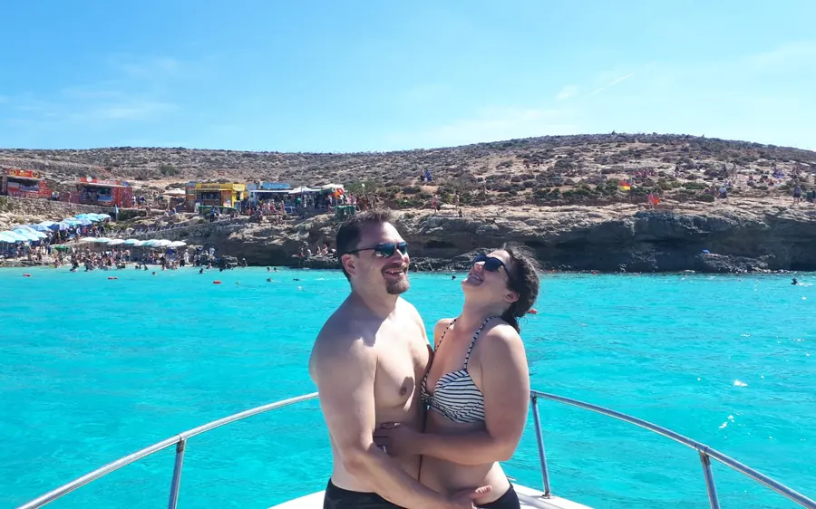 A couple on a private boat off Comino, Malta
