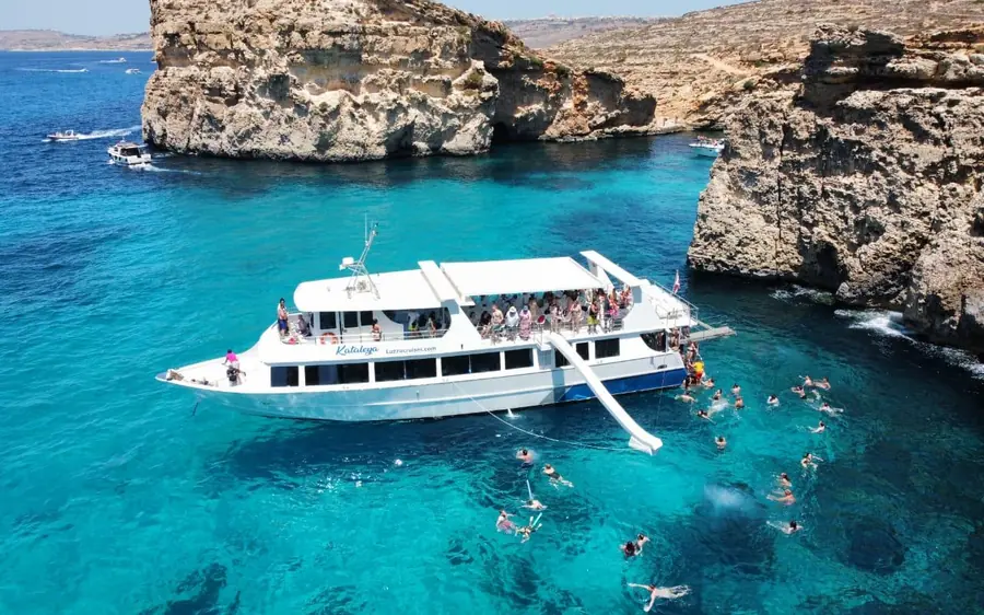 A large tour boat in the Blue Lagoon at Comino