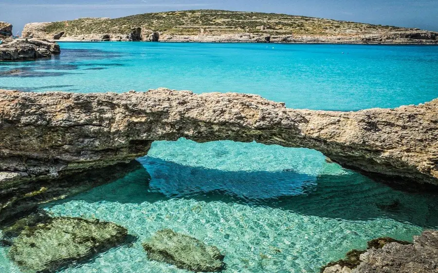 Crystal-clear water over rocks at the Crystal Lagoon, Comino